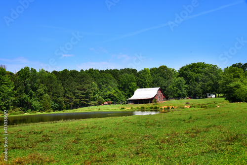 Barn With Pond in Large Field