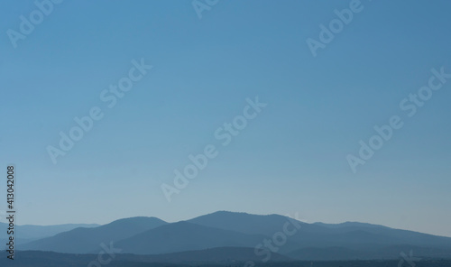 Hazy Distant Mountains Against a Clear Blue SKy