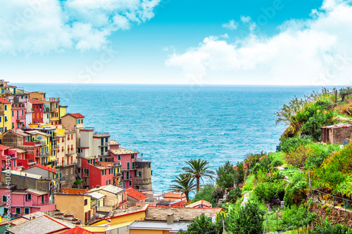 Manarola in cinque terre on the mountain near mediterranean sea in liguria - Italy. Sunny cloudy sky. Traditional italian architecture