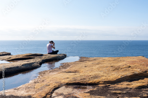 Young Woman lady Practicing Yoga on a cliff overlooking the ocean at Sunrise, Healthy Lifestyle  © Em Neems Photography
