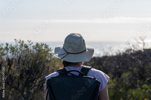 back view photo of young female hiker on the hiking trail in the Royal National Park, NSW.  © Em Neems Photography