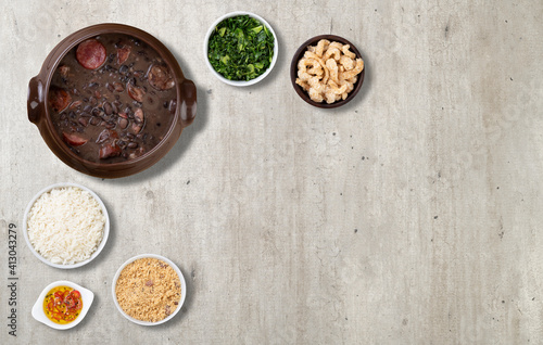 Traditional brazilian feijoada with rice  kale  manioc flour  cracklings and copy space
