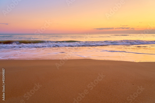 Sandy tropical beach at sunset as a backdrop.