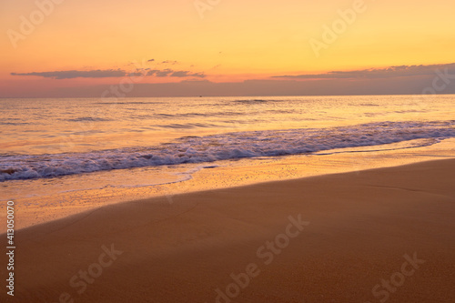 Fototapeta Naklejka Na Ścianę i Meble -  Sandy tropical beach at sunset as a backdrop.