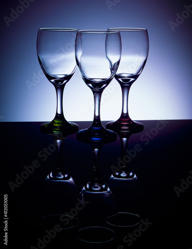 Empty wine glasses with colored stems
