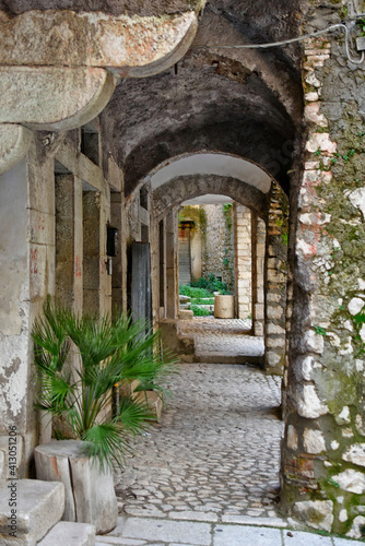 A narrow street between the old houses of Guardia Sanframondi  a medieval village in the province of Salerno  Italy.