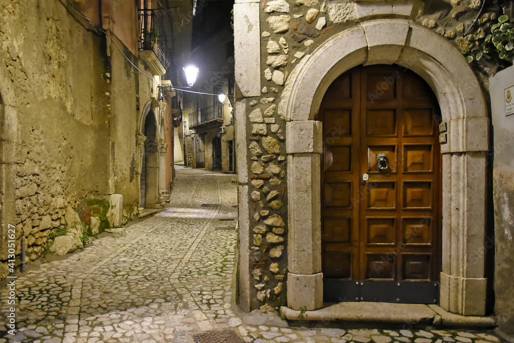 Fototapeta premium A narrow street between the old houses of Guardia Sanframondi, a medieval village in the province of Salerno, Italy.