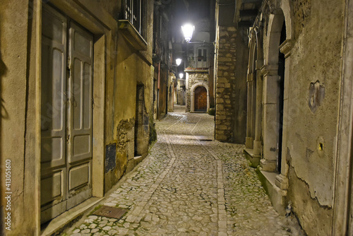 Fototapeta Naklejka Na Ścianę i Meble -  A narrow street between the old houses of Guardia Sanframondi, a medieval village in the province of Salerno, Italy.