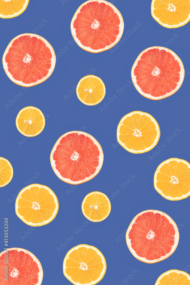Lemon, orange and grapefruit on a blue background, cut in half and sorted by size. Flat lay. Lemon, orange and grapefruit on a blue background, cut in half and sorted by size. Flat lay.