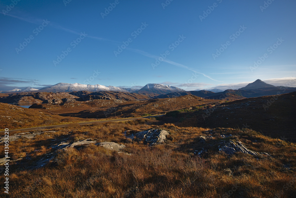 Obraz premium Snow on the mmountains from the A838 North of Scourie, Sutherland, North West Scotland, UK