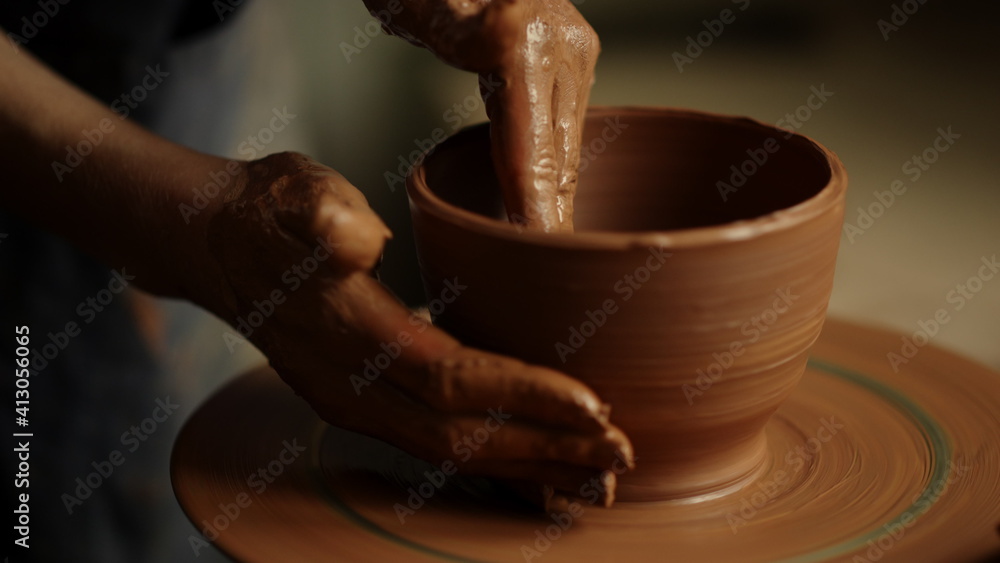 Girl shaping clay product in pottery. Woman sculpting clay pot in workshop Girl shaping clay product in pottery. Woman sculpting clay pot in workshop