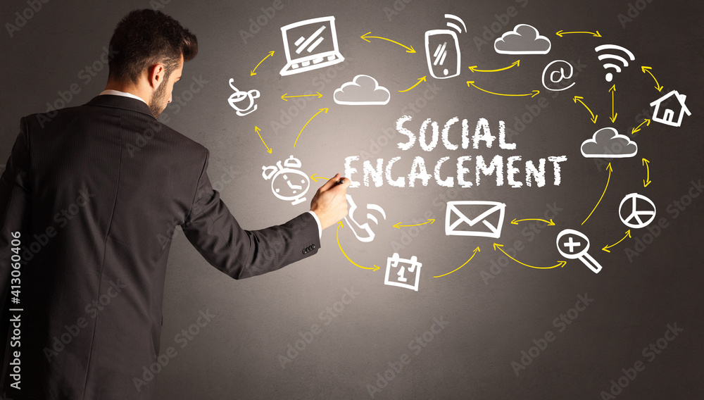 businessman drawing social media icons with SOCIAL ENGAGEMENT inscription, new media concept businessman drawing social media icons with SOCIAL ENGAGEMENT inscription, new media concept