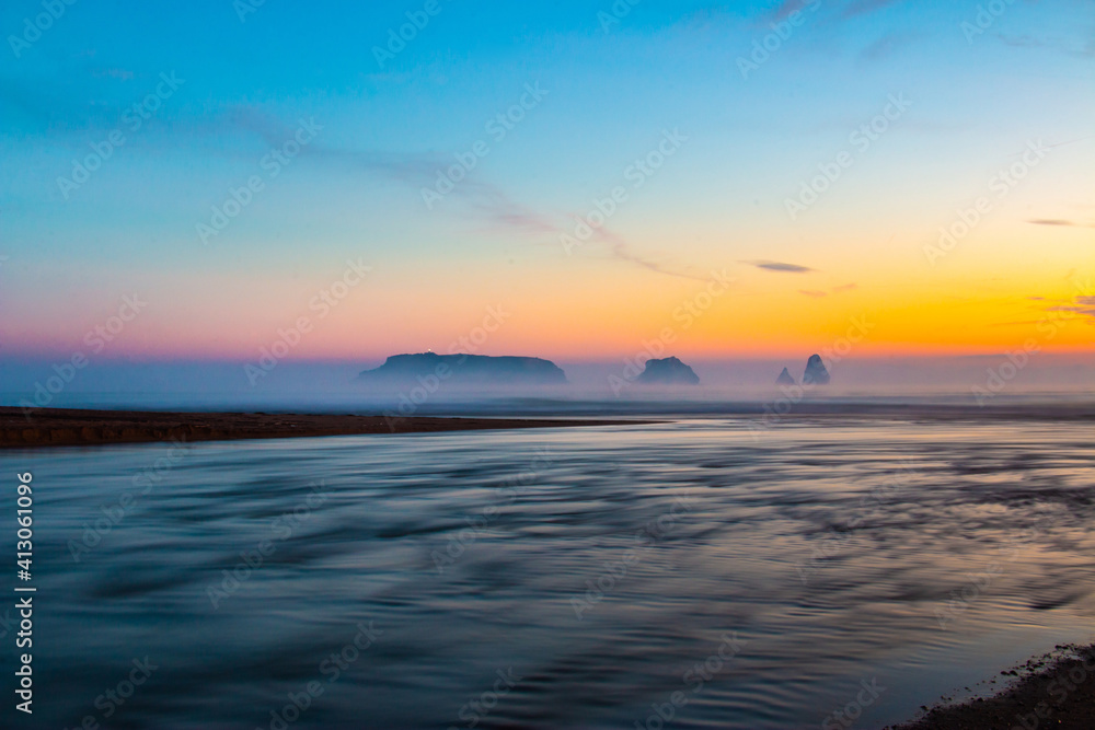 Landscape of a river flowing at dawn in morning with a calm atmosphere with mist. Mouth of river Ter in the Mediterranean Sea with the Medes Islands. Tourism Torroella de Montgri, Ampurdán, Catalonia.