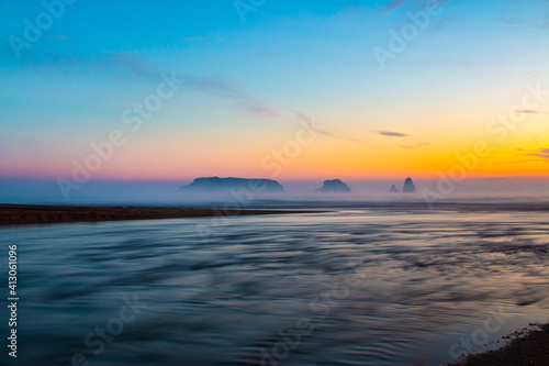 Landscape of a river flowing at dawn in morning with a calm atmosphere with mist. Mouth of river Ter in the Mediterranean Sea with the Medes Islands. Tourism Torroella de Montgri  Ampurd  n  Catalonia.
