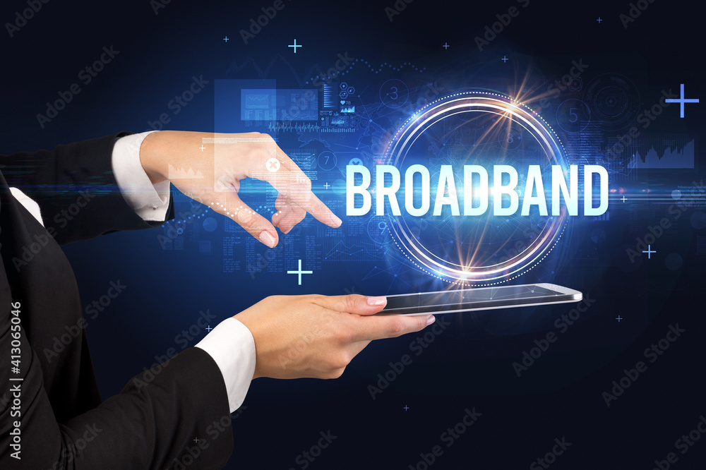 Close-up of a touchscreen with BROADBAND inscription, new technology concept Close-up of a touchscreen with BROADBAND inscription, new technology concept