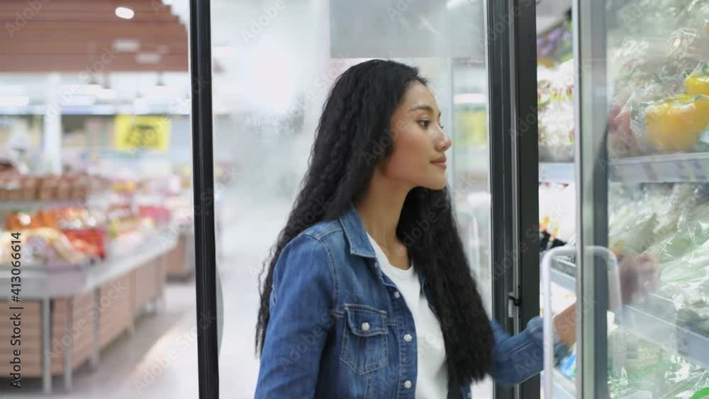 Shopping concepts of 4k Resolution. Asian women choose fresh vegetables in their refrigerators. Shopping concepts of 4k Resolution. Asian women choose fresh vegetables in their refrigerators.