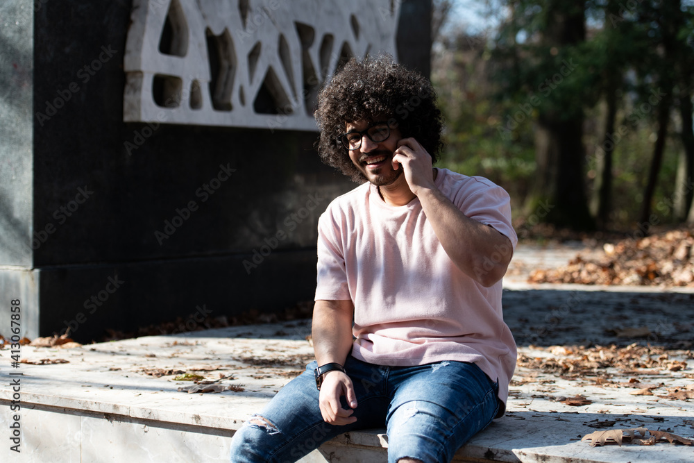 Bearded Smiling Man Touching Phone in Park Bearded Smiling Man Touching Phone in Park