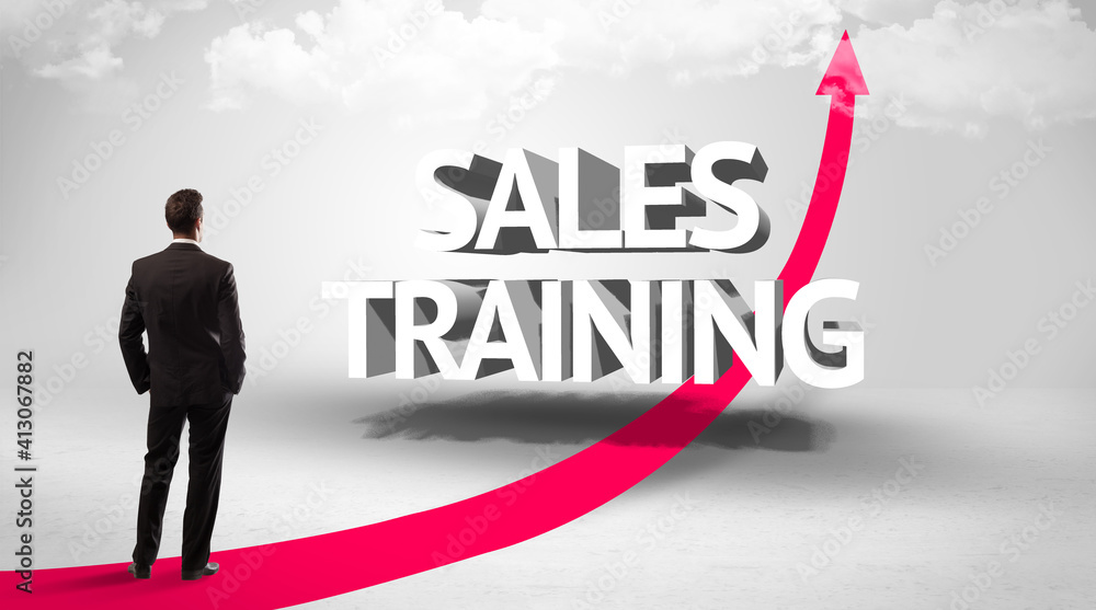 Rear view of a businessman standing in front of SALES TRAINING inscription, successful business concept Rear view of a businessman standing in front of SALES TRAINING inscription, successful business concept