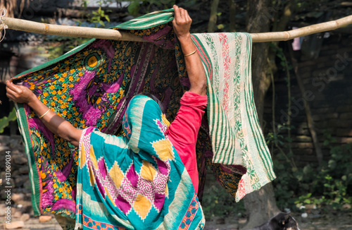 Woman drying laundry, Bagerhat, Khulna Division, Bangladesh photo