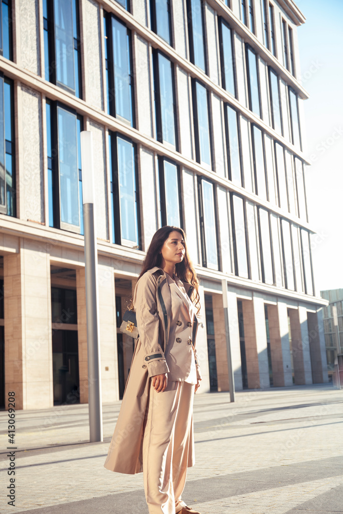 young pretty brunette woman in fashion suit at business building posing cheerful, lifestyle people concept