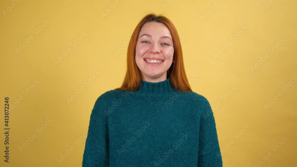 Smiling cheerful funny young woman 20s years old posing isolated on yellow color background studio. People sincere emotions lifestyle concept. shot in slow motion Smiling cheerful funny young woman 20s years old posing isolated on yellow color background studio. People sincere emotions lifestyle concept. shot in slow motion