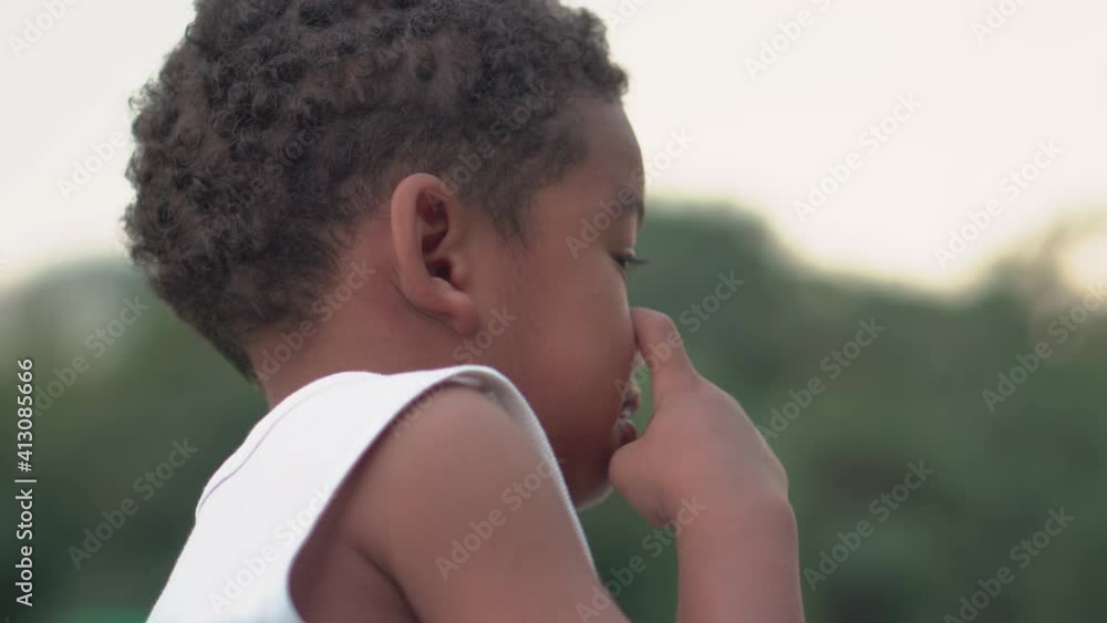 Portrait of Afican american boy, Happy kid playing in a park Portrait of Afican american boy, Happy kid playing in a park