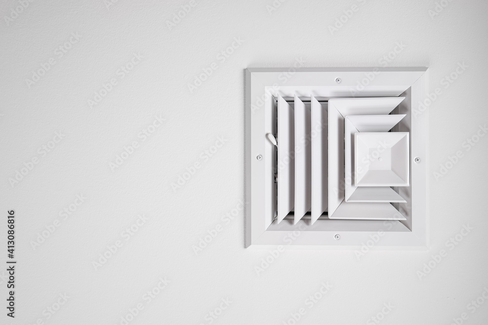Photograph of a residential ceiling heating and cooling vent painted white Photograph of a residential ceiling heating and cooling vent painted white
