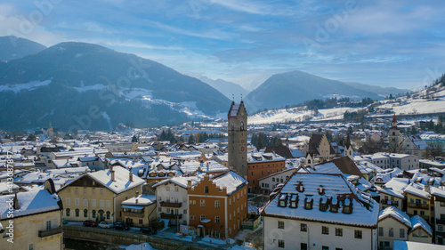 Twelve o'clock Tower in Vipiteno - Sterzing: is a little town in South Tyrol in Wipptal, northern Italy. Aerial view of the old city center with "Torre delle Dodici" in winter time and snowy roofs.