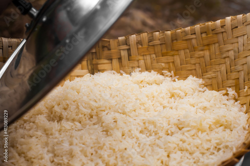 Open the lid of the steamed sticky rice.Steamed sticky rice.Sticky rice is the food of Thai people. photo