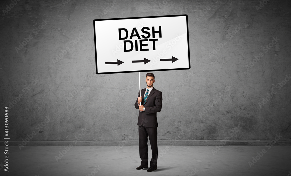 business person holding a traffic sign with DASH DIET inscription, new idea concept business person holding a traffic sign with DASH DIET inscription, new idea concept