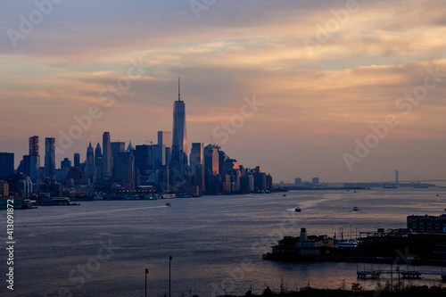 New York City, Lower Manhattan, the Hudson River, and Upper New York Bay at twilight as seen from Weehauken, New Jersey, USA with Brooklyn and the Verrazano Bridge in the distance