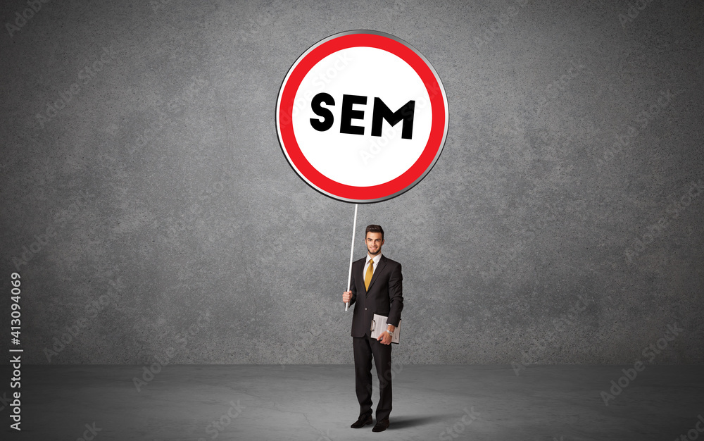 Young business person holdig traffic sign with SEM abbreviation, technology solution concept Young business person holdig traffic sign with SEM abbreviation, technology solution concept
