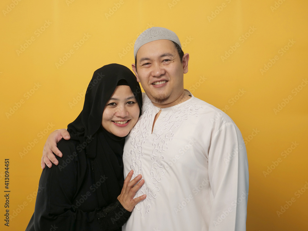 Portrait of happy Asian muslim couple smiling, husband and wife hugging full of love, family Portrait of happy Asian muslim couple smiling, husband and wife hugging full of love, family