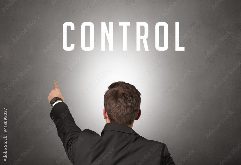 Rear view of a businessman with CONTROL inscription, cyber security concept Rear view of a businessman with CONTROL inscription, cyber security concept