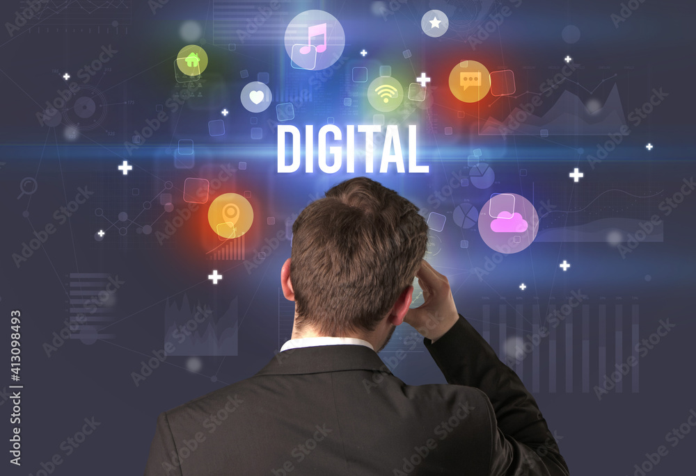Rear view of a businessman with DIGITAL inscription, modern technology concept Rear view of a businessman with DIGITAL inscription, modern technology concept