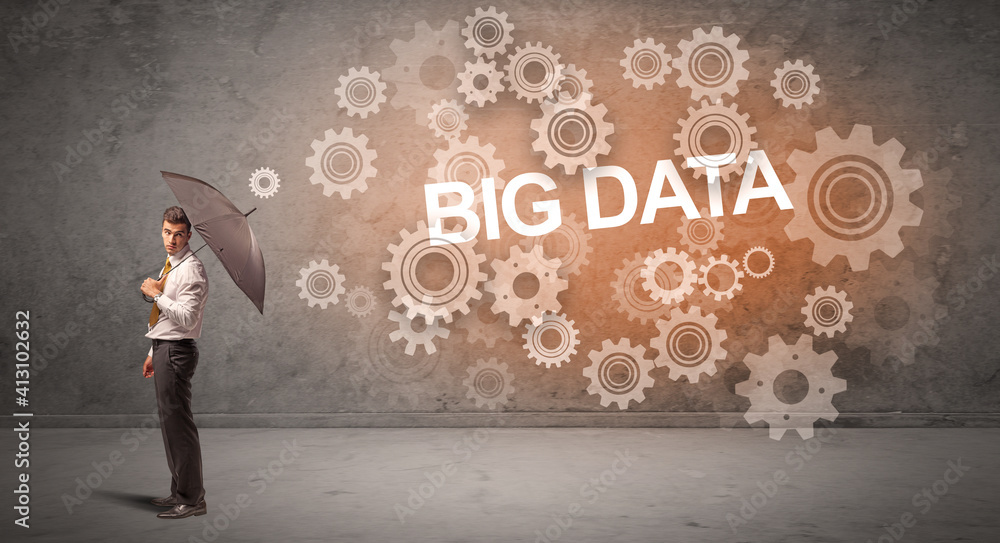 Businessman defending with umbrella from BIG DATA inscription, technology concept Businessman defending with umbrella from BIG DATA inscription, technology concept