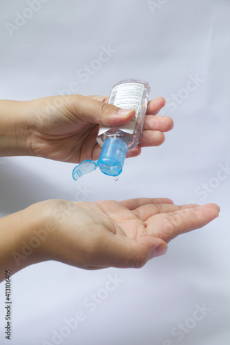 applying sanitizer in both hands