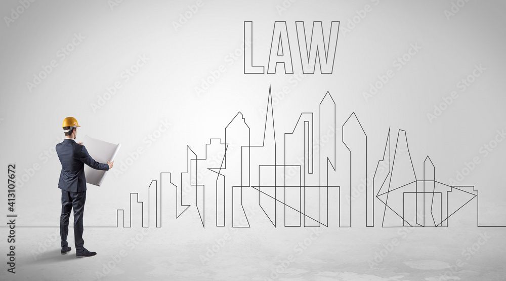 Businessman in hard hat holding blueprint with LAW inscription, engineering and architecture concept Businessman in hard hat holding blueprint with LAW inscription, engineering and architecture concept