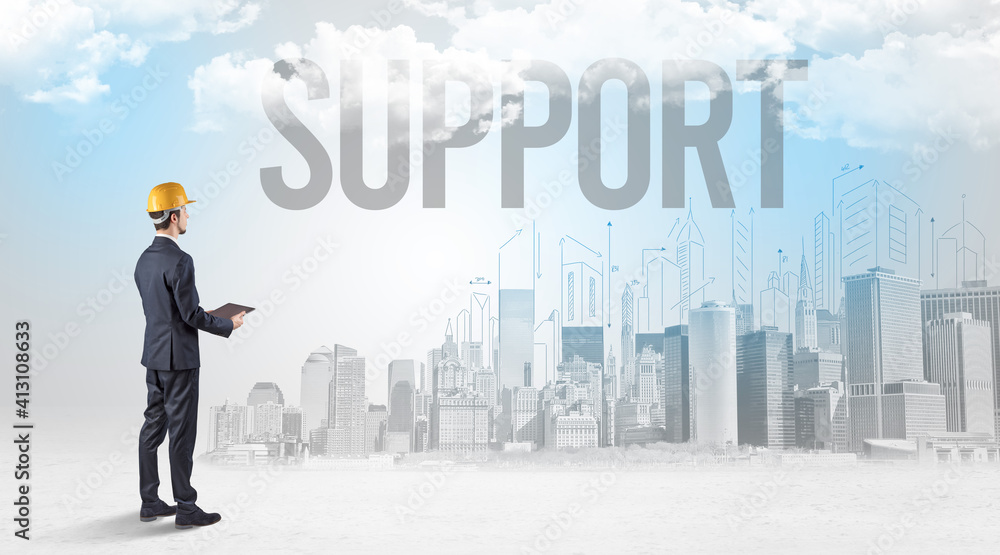 Young businessman with hard hat and SUPPORT inscription, new business opportunity concept Young businessman with hard hat and SUPPORT inscription, new business opportunity concept