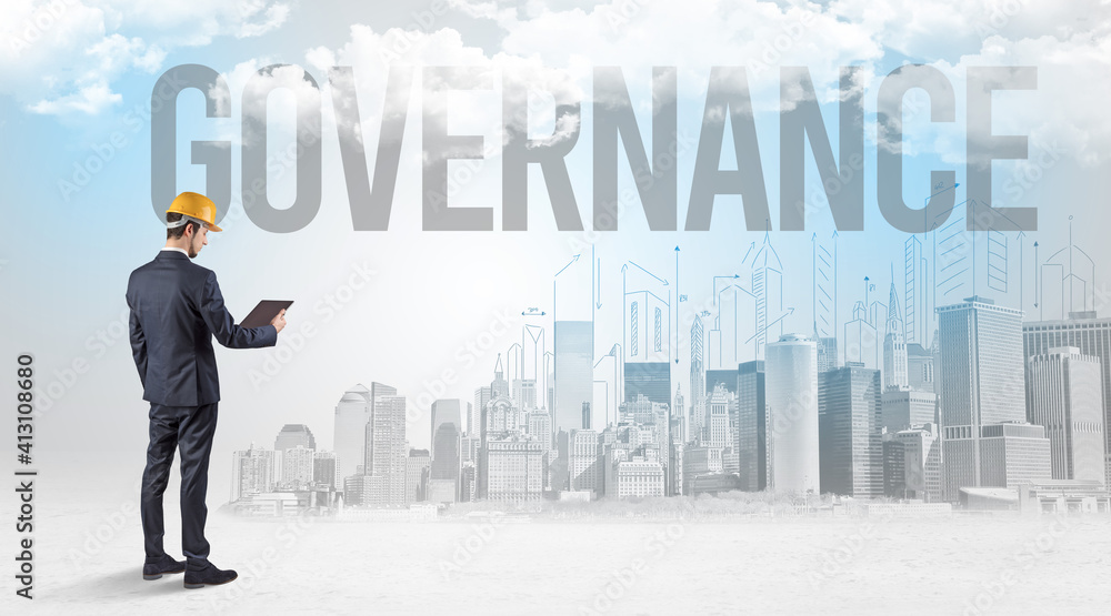 Young businessman with hard hat and GOVERNANCE inscription, new business opportunity concept Young businessman with hard hat and GOVERNANCE inscription, new business opportunity concept