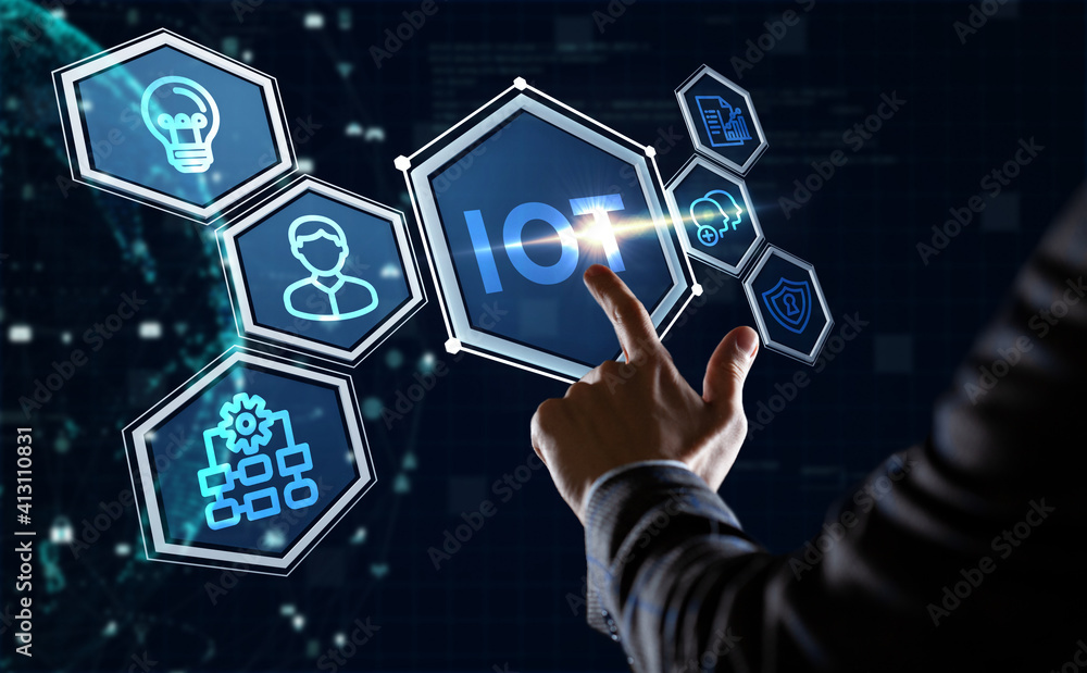 Internet of things - IOT concept. Businessman offer IOT products and solutions. Young businessman select the abstract chip with text IoT on the virtual display. Internet of things - IOT concept. Businessman offer IOT products and solutions. Young businessman select the abstract chip with text IoT on the virtual display.