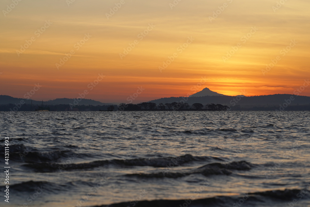 Freshwater sea before sunrise with mountain background
