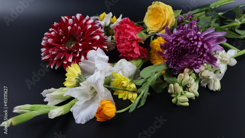 Close up. Beautiful bouquet of blooming colorful bright flowers isolated in dark background. 