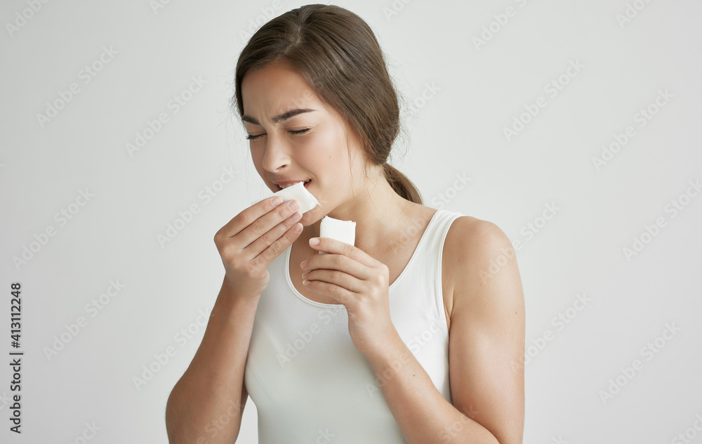 woman wiping her face with a handkerchief feeling unwell health cold woman wiping her face with a handkerchief feeling unwell health cold