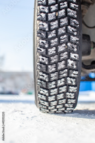 Car tires on the winter road are covered with snow. © Анатолий Савицкий