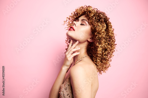 Beautiful woman touches the neck with his hand fashionable clothes background