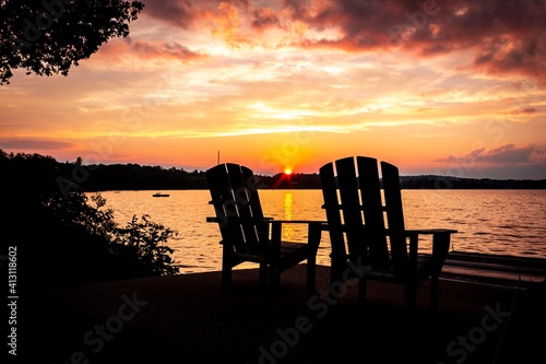 Foto two chairs lakeside with a sunset