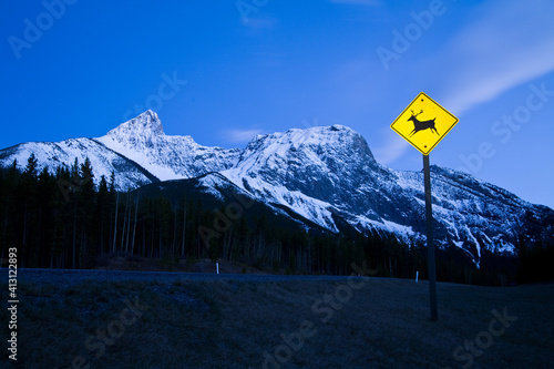 Caution deer or wildlife sign in the mountains at night in Kananaksis, Alberta, Canada