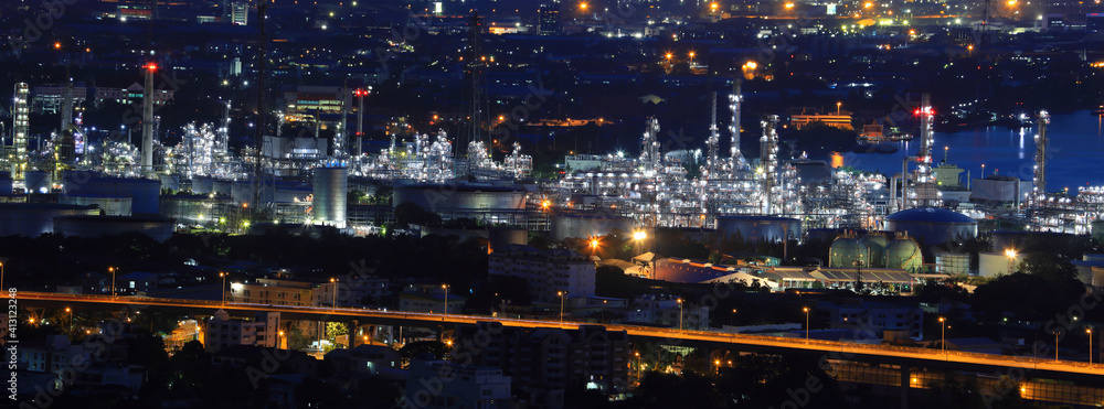 Crude oil refinery factory plant for gasoline and petroleum industry at night in panorama for petrochemical concept