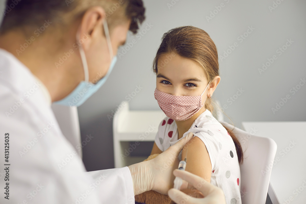 custom made wallpaper toronto digitalVaccination against coronavirus for children concept. Little positive girl patient in medical protective mask getting vaccination injection with syringe against covid-19 during pandemic in clinic
